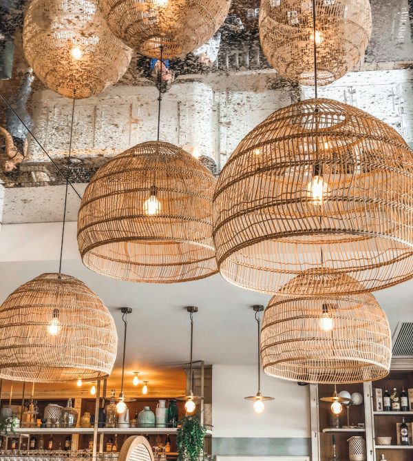 Stylish wicker pendant lights enhancing the ambiance of a modern French café in Alfortville, France.